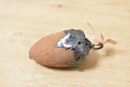 A late 19th-century white metal and fabric acorn pin cushion, thought to be American, featuring