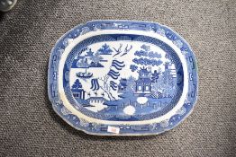 A large 19th-century ironstone ‘Willow’ platter, featuring a Chinoiserie landscape motif, the