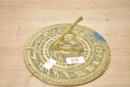 A mid to late 20th-century brass 'Sunny Hours' sundial, marked to front, 18cm diameter, condition is