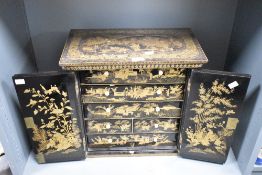 A large 19th-century Chinese black lacquer table cabinet, thought to be Qing Dynasty, featuring