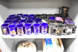 A large quantity of mid to late 20th-century Portmeirion pottery commemorative tankard mugs, all