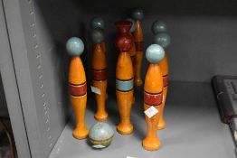 A set of late 19th-century turned wood table skittles with original ball, featuring hand-painted