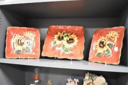 Three late 20th-century ceramic hand-painted sunflower decorated serving dishes, of square form,
