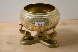A 20th-century Sri Lankan brass Ali Paththaraya bowl, presented upon an elephant-formed stand,