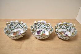 A group of three 20th century Italian hand painted porcelain basket, featuring a green lattice