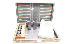 A late 19th-century wooden backgammon and chess set, of folding book form; sold with two purple