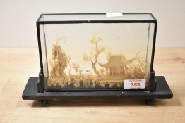 A 20th-century Chinese hand carved cork diorama in a dark brown lacquer and glass display case,