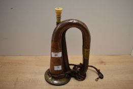 A 20th-century copper and brass military bugle, featuring a bone mouthpiece and a deep green, blue