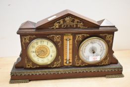 A late 19th to early 20th-century French-style oak and gilt-metal mounted desk clock and barometer