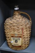 A large vintage William and Humbert 'Cedro' Sherry in a wicker-wrapped glass demi John bottle,