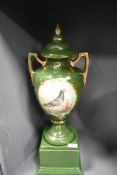 A tall early 20th-century ceramic Racing Pigeon trophy and plinth, of urn form with twin gilt