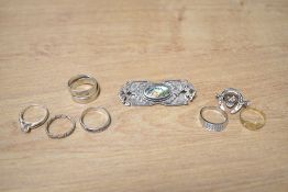 A small collection of silver jewellery, comprising two brooches and six rings, 32g gross