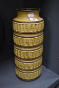 A tall mid-century West German pottery floor vase, featuring five-bands of repeating geometric