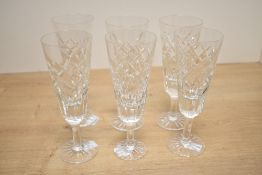 A set of six 20th-century Waterford-style crystal glass champagne flutes, featuring a cut crystal