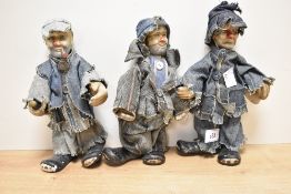 A group of three pottery clown/hobo figures, each dressed in denim, 20cm