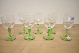 A quantity of seven mid 20th-century green stem sherry glasses, featuring etched floral decoration