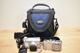 Two digital cameras. An Olympic Camedia C-765 and a Lumix Panasonic DMC-TZ20 in soft camera bag with