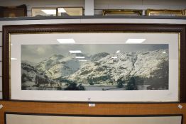 A large panoramic art print of a snowy mountain scene possibly Lake District, signed Linda Moore