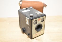 A vintage Kodak Brownie Model I camera in a canvas bag