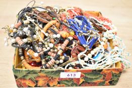 A collection of costume jewellery, including faux branch coral, wooden pieces, beaded jewellery