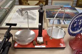 A 20th-century metal scale, having various brass weights, 32cm.