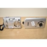 Three digital cameras. A Sony DSC-TX30 boxed, a Fujifilm A303 (with booklet) and a Vivitar DVR