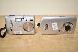 Three digital cameras. A Sony DSC-TX30 boxed, a Fujifilm A303 (with booklet) and a Vivitar DVR