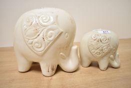 Two contemporary ceramic decorative elephants, having a soft cream-coloured glaze, (2), condition is