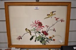 A Chinese style silk embroidery featuring a bird on a branch with peony flowers framed and glazed