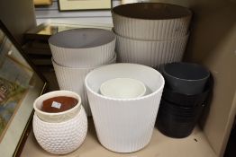 A large selection of predominately white planters in various large sizes, measurements include two