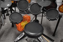 An Alesis electric drum kit (8 piece) including Nitro module, having the quieter mesh pads (quieter)