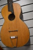 An antique Parlour guitar having later tailpiece and steel strings, no visible label, in card case