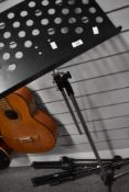 Two modern boom mic stands and a music stand