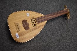 A traditional lute of naive construction , with 5 nylon strings