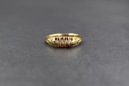 An 18ct gold diamond chip set ring, the graduated diamonds in claw settings, four being old cut with