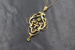 An Edwardian 9ct gold paste and seed pearl set pendant, the central green paste in an openwork