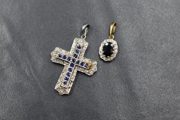 A 9ct white gold cross pendant having sapphire chip decoration and a small 9ct gold sapphire