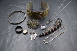 A small selection of white metal and silver jewellery including a Celtic Hound cuff bangle,