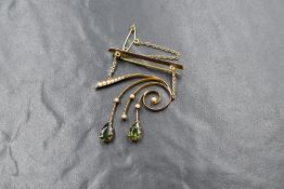 A 9ct gold green tourmaline and seed pearl set brooch, the bar brooch having a seed pearl set