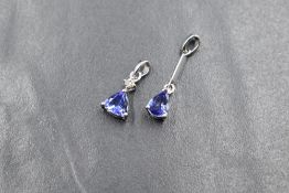 A 9ct white gold diamond and tanzanite set pendant, the round brilliant cut diamond measuring
