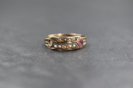 A Victorian 9ct gold band ring having seed pearl and spinel decoration, several stones missing,