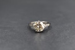 An 18ct white gold and platinum diamond set solitaire ring, the round brilliant cut diamond