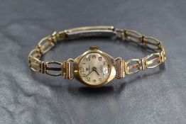 A 9ct gold cased Perona wristwatch, the champagne dial having Arabic numerals, on a rolled gold