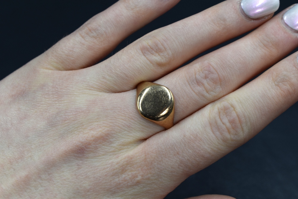 A yellow metal presumed gold signet ring, having an oval panel of plain form, unmarked, ring size S, - Image 3 of 3