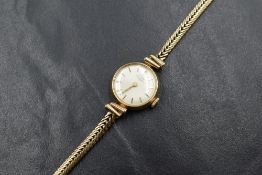 A 9ct gold Girard Perregaux wristwatch, the champagne dial having baton five minute markers,