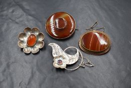 A Victorian silver carnelian set brooch, the central oval carnelian cabochon in a floral setting,