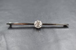 An 18ct gold and platinum diamond set bar brooch, the central round brilliant cut diamond
