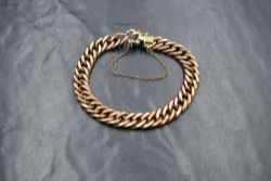A 9ct rose gold curb link bracelet, having a box clasp, marked 375, 11.9g