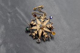A 9ct gold pearl set Eastern Star brooch, the pierced floral motif star brooch set with a central