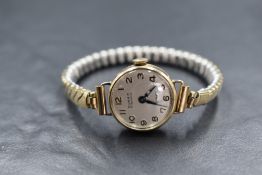 A 9ct gold Summit wristwatch, the champagne dial having Arabic numerals, marked 375, on a